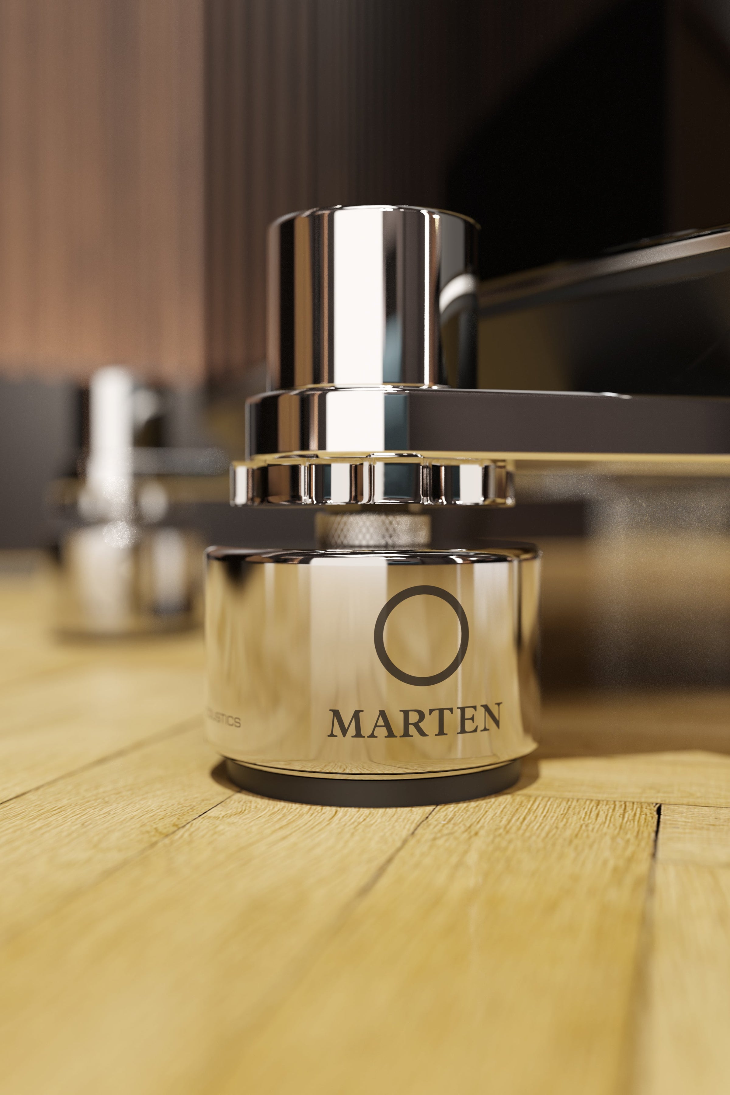 Silver isolator with 'Marten' branding on a wooden floor